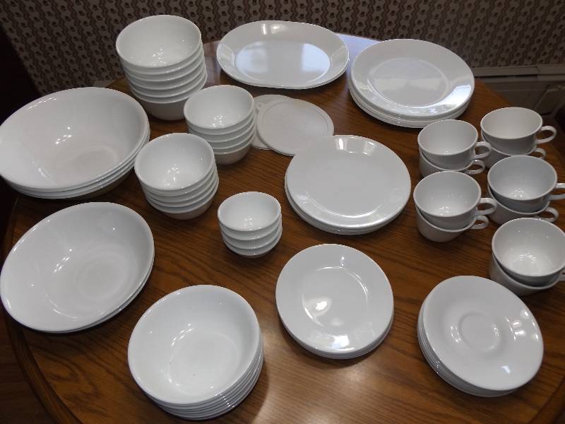 White Corelle dishes including 9 lg plates, 8 med plates, 8 sm plates, 10 cups, 12 saucers, 2 platters, storage bowls wlids 6 lg bowls, 10 med, 4 sm., 4 large bowls, 2 med bowls, 9 cereal bowls.