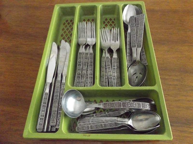 Orleans silverware set in green holder.
