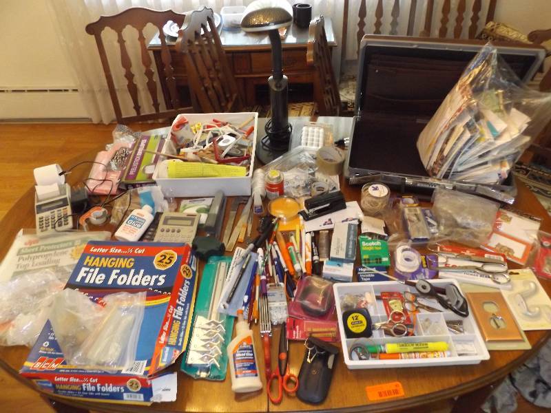 Variety of office supplies, lamp, briefcase.
