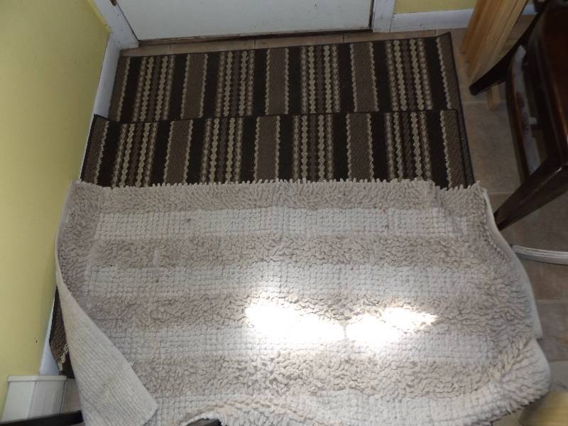 3 rugs (2 browns, 1 cream)