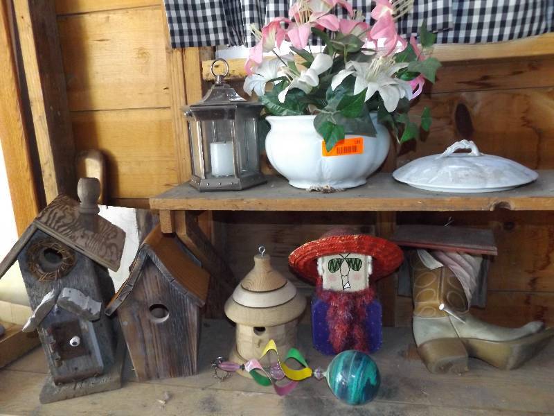 Variety of birdhouses and yard decorations.