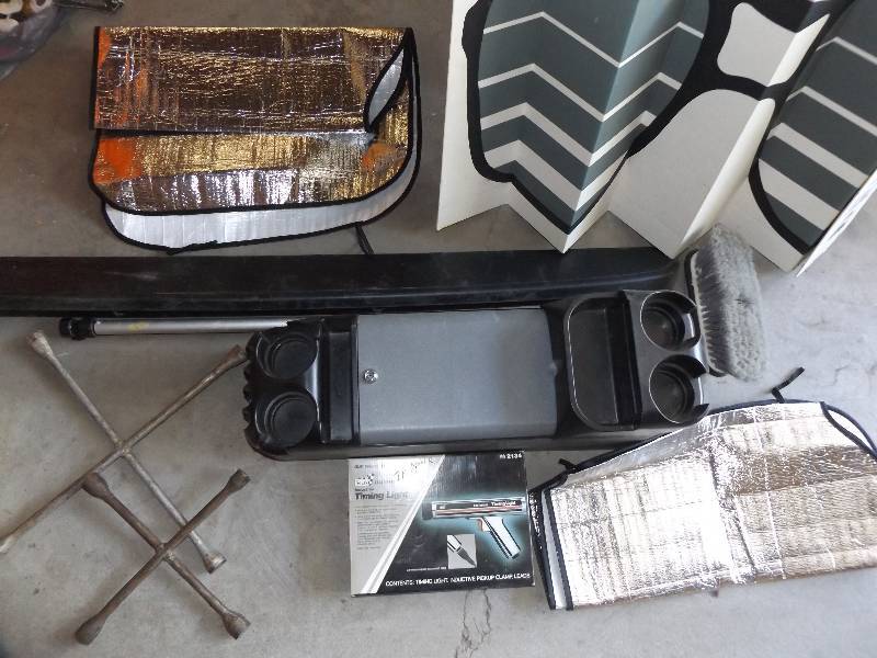 2 tire irons, timing light, center console, 3 window shades, bumper, brush