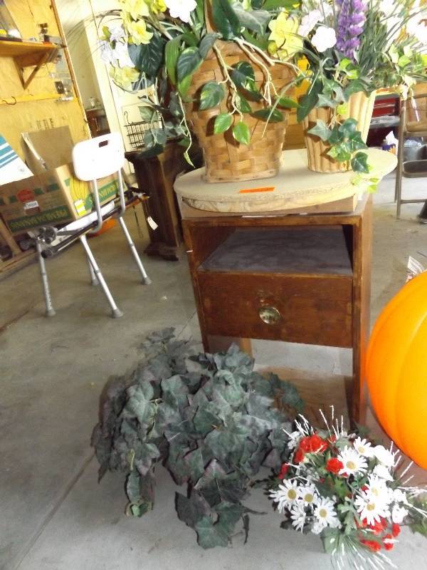 Homemade round top table cabinet with planters.