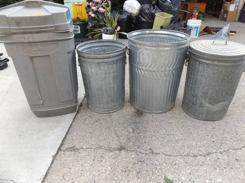 3 garbage cans (3 metal & 1 plastic)