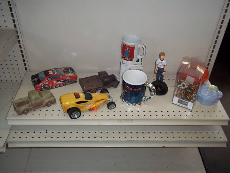lot 29 image: Coffee cups, dcor wood cars, tin car, and toy car with dcor items