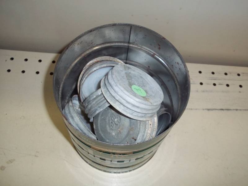 lot 55 image: Metal canning jar lids in coffee can