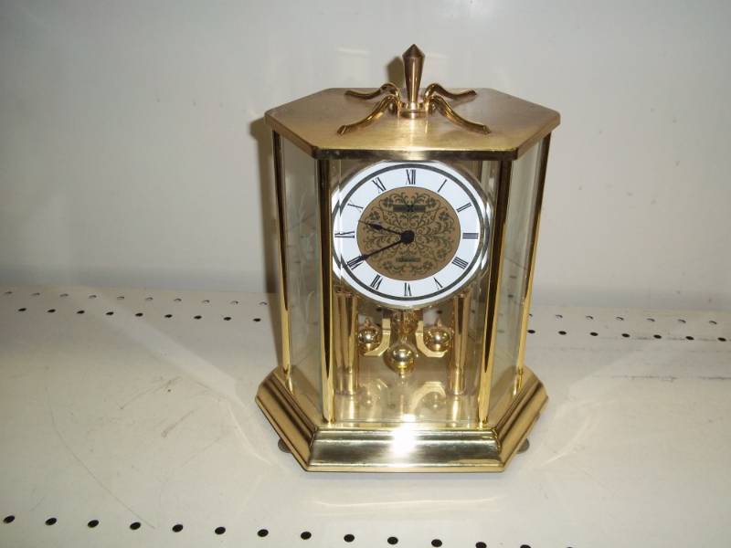 lot 122 image: Rotating Pendulum Clock with glass