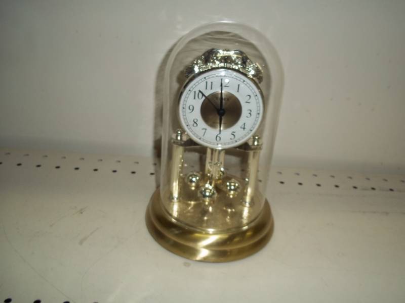 lot 124 image: Rotating Pendulum Clock with glass
