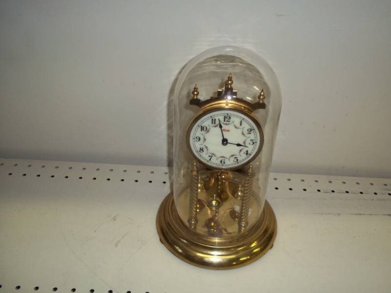 lot 125 image: Rotating Pendulum Clock with glass