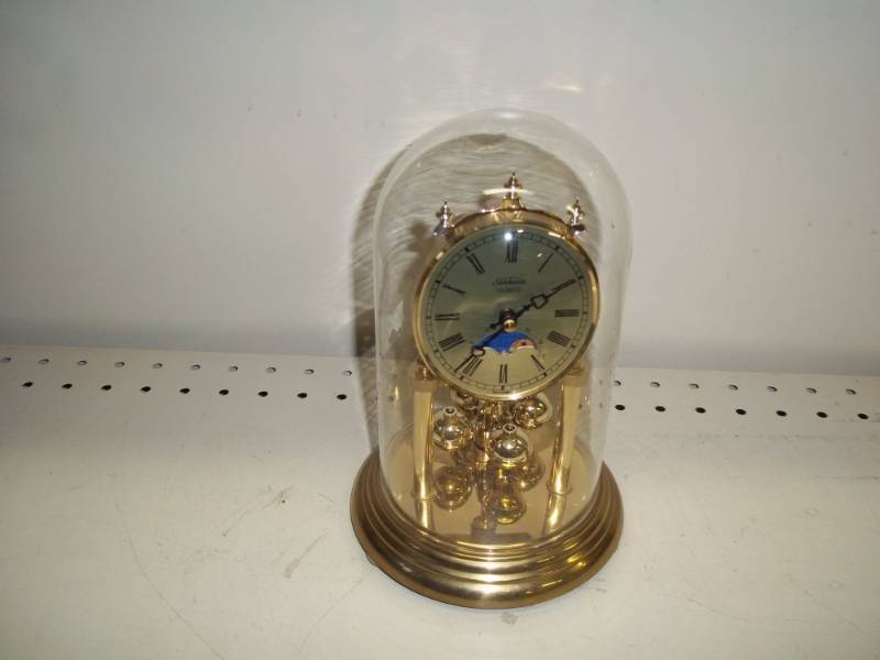 lot 126 image: Rotating Pendulum Clock with glass