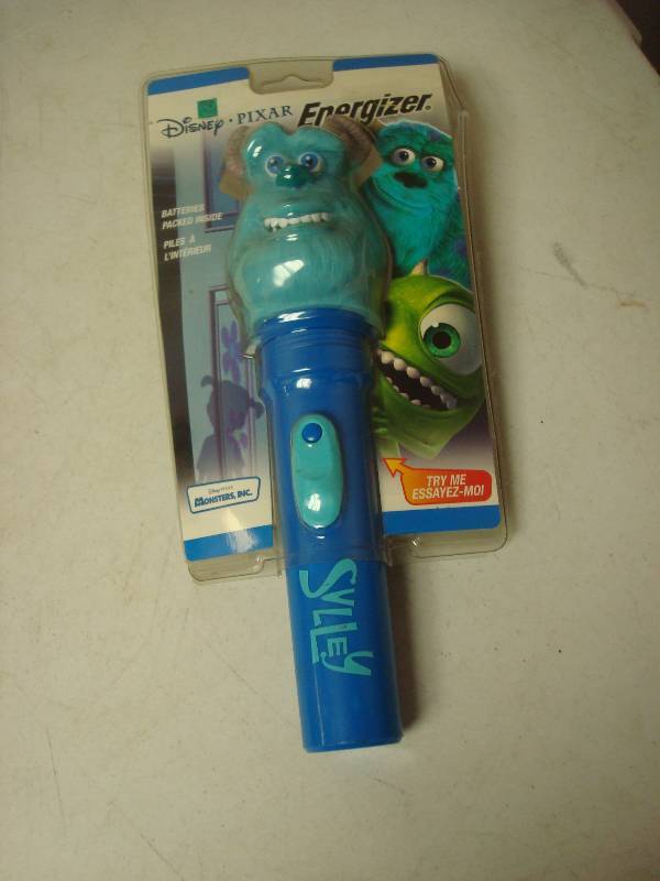 lot 69 image: Monsters Inc Flashlight, Unused, Some Wear To Package