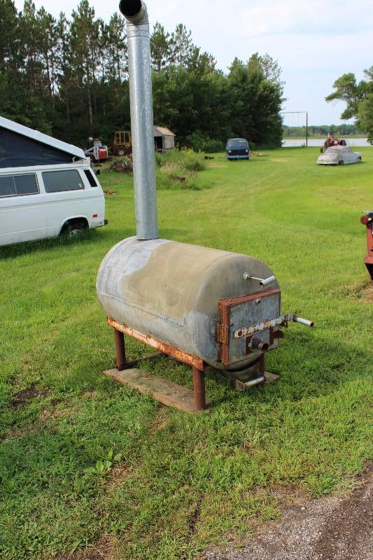 lot 24 image: Galvanized Burn Barrel with Cleaning attachment and Ashes Drawer for Easy Cleaning.  Only used for Testing.  Works Great - Heats workshops in no time.   63 x 28 x 48.