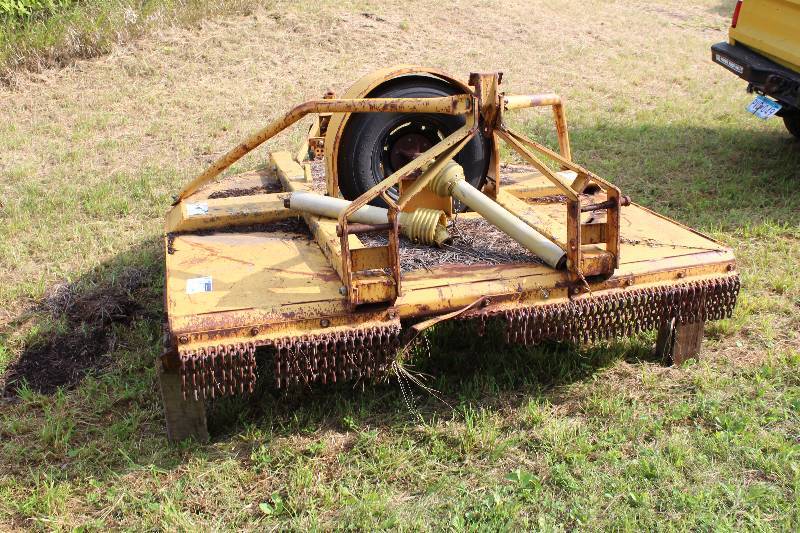 lot 15 image: Side Winder Mowing Deck Model SW 7 Serial No. 853506 84 x 84 Deck.  Drives with Tire instead of Hydraulic drive off tractor.  Drives off PTO from Tractor.  Very unusual.  Heavy Duty.