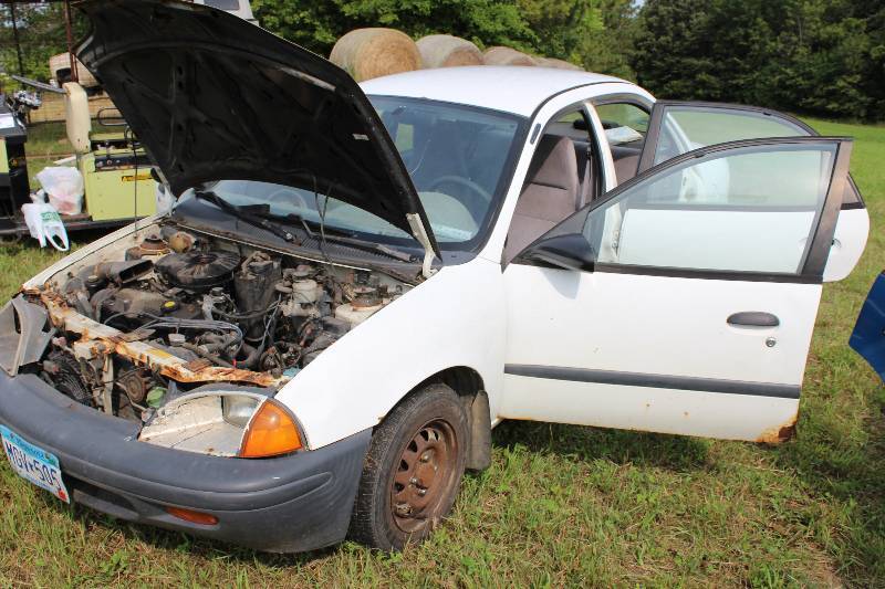 lot 12 image: 1996 Geo Metro VIN 2C1MR5299T6748917 Mileage 271,400 License Plate MGV 505 L4, 1.3L (79 CID) Gasoling Engine, Automatic Transmission, Front Wheel Drive, Four Door Sedan. Tow Away Vehicle