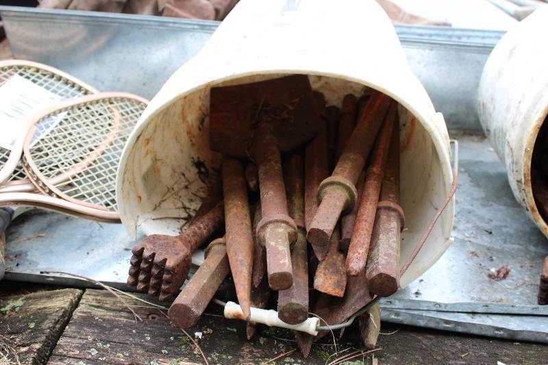 lot 99 image: Bucket Lot Including Metal Shovel Blade Bit Large Drill Bits Jack Hammer Attachments And More.