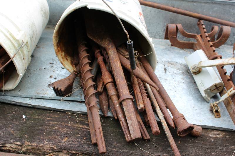 lot 98 image: Bucket Lot Including Metal Shovel Blade Bit Large Drill Bits Jack Hammer Attachments And More.