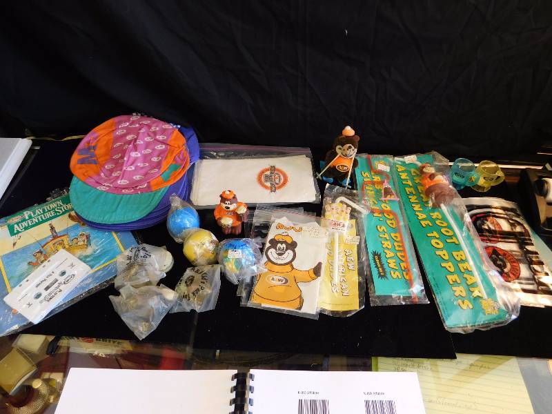 lot 74 image: many A&W collectible items figurine, drinking straws, hats, toys from kids meals and more
