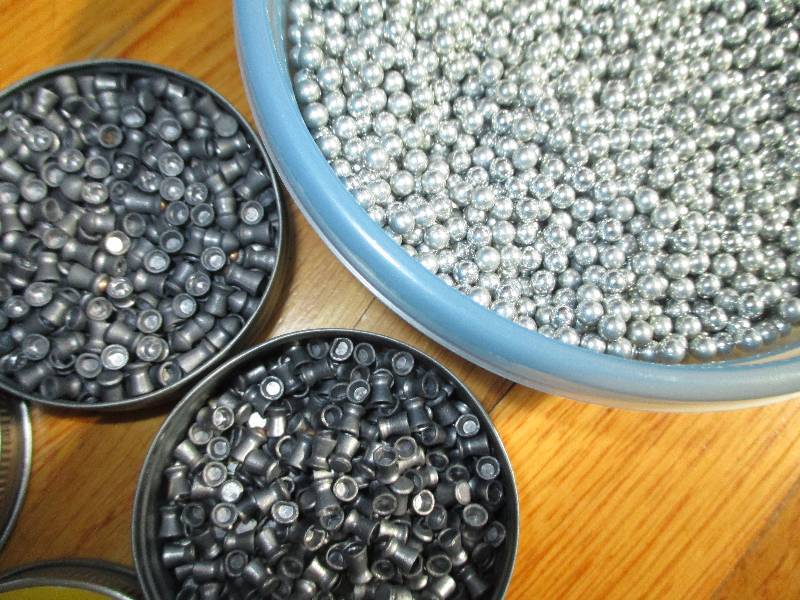 Container of steel BBs and 2 cans o...