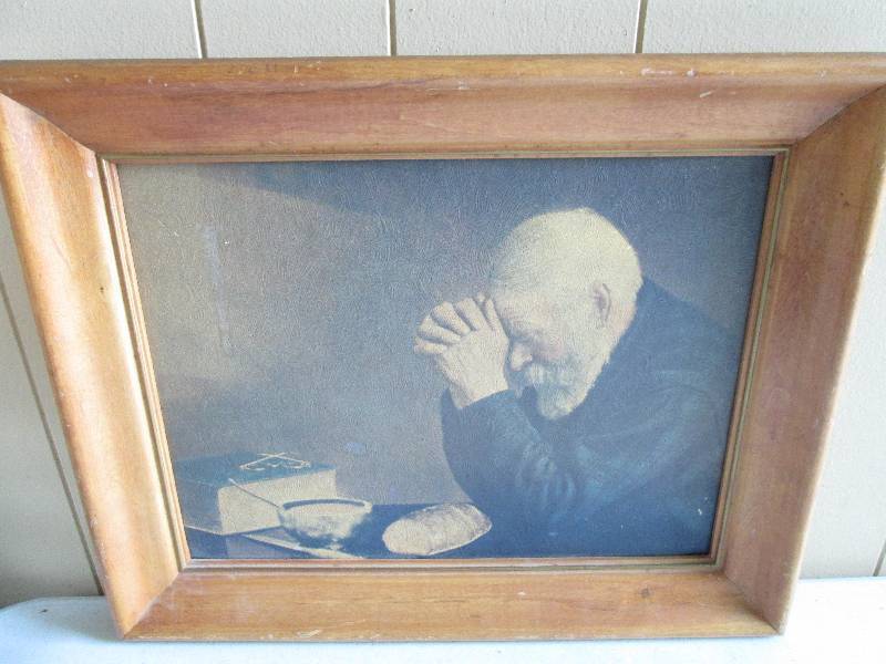 Older man praying over his meal, no...