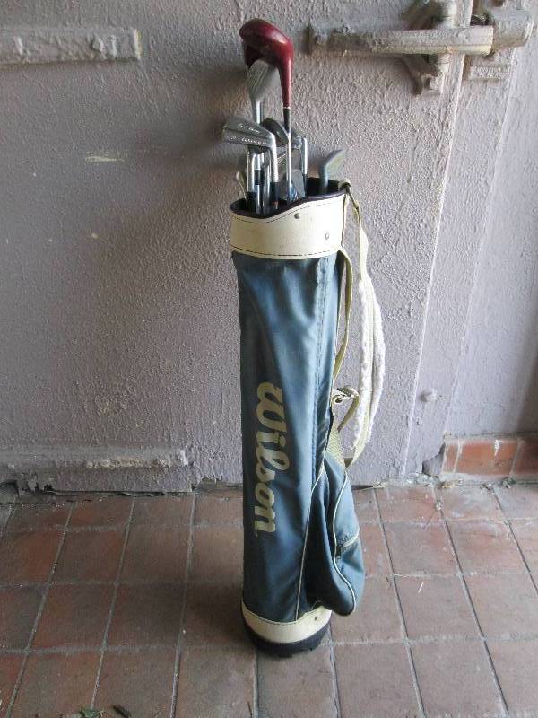 Golf bag full of golf clubs, putter...