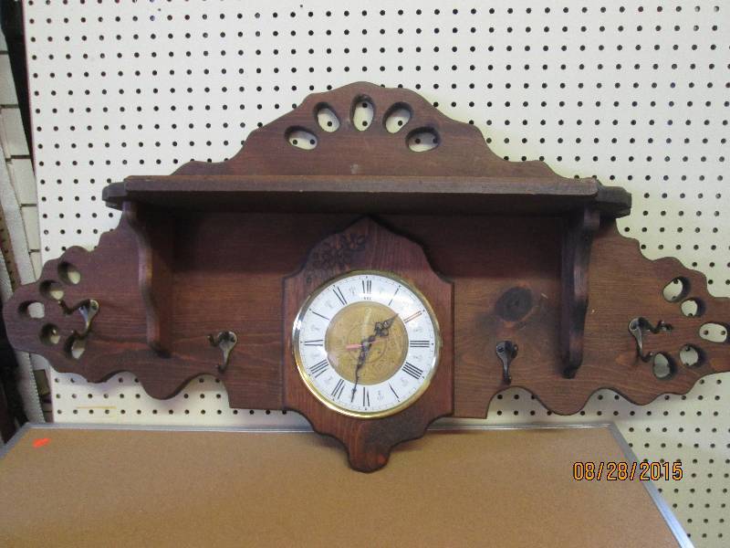 Beautiful clock shelf, made by the Amish.  Very nice eye-catching piece, 42 long, 21.5 high, shelf is 27 long, and 7 high.  Works and keeps perfect time, has 4 coat hangers