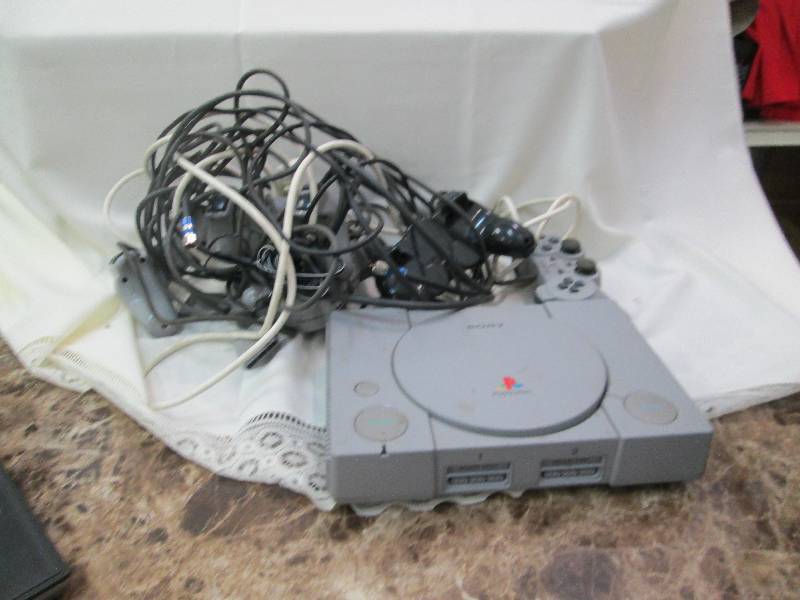 lot 26 image: Sony Play station with remotes used...