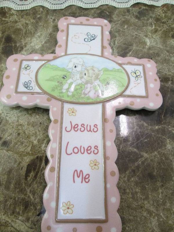 Pink cross that say Jesus loves me...
