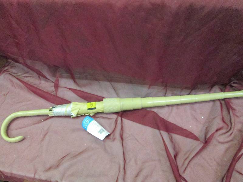 beige umbrella with cover...
