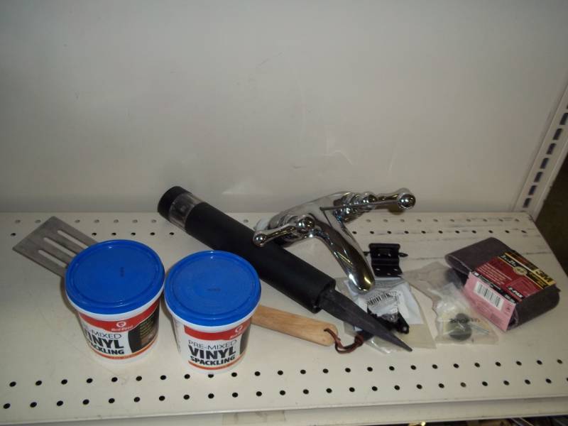lot 53 image: Vinyl spackling, bathroom faucet, solar light, and grill spatula