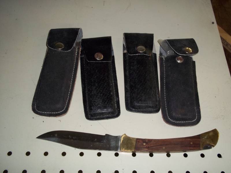 lot 180 image: 4 lock back knives with leather sheath
