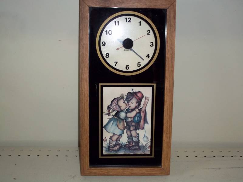 lot 187 image: Little boy and girl clock