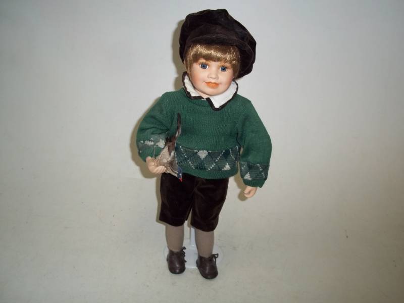 lot 246 image: 18 in Porcelain Boy Doll with bird