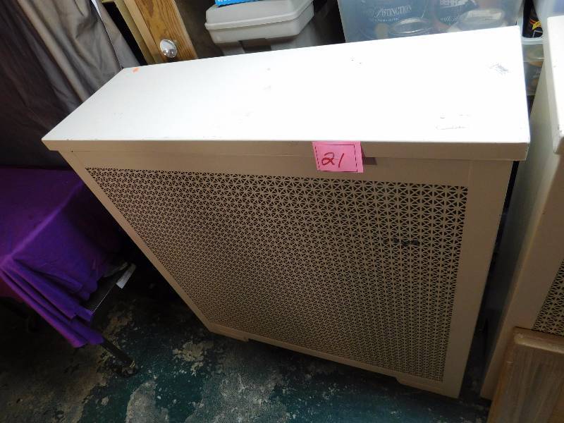 large white radiator cover. Lid lifts open and closes for a flat surface.