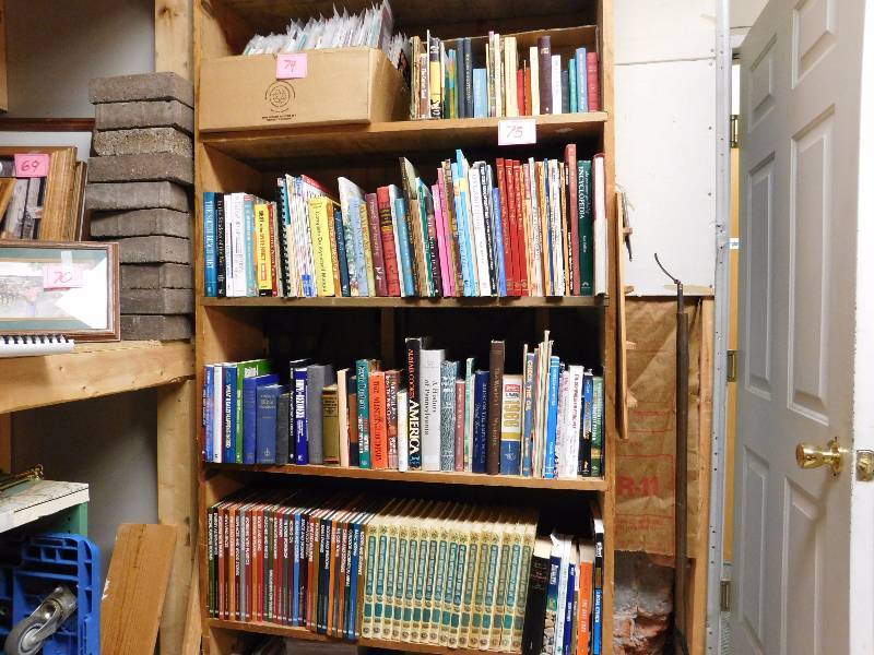 several shelves of books many topics and authors some are vintage