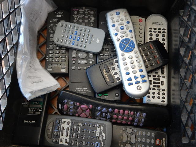 lot 58 image: Milk Crate of remote controls.. Untested.. Emerson TVRadio combo