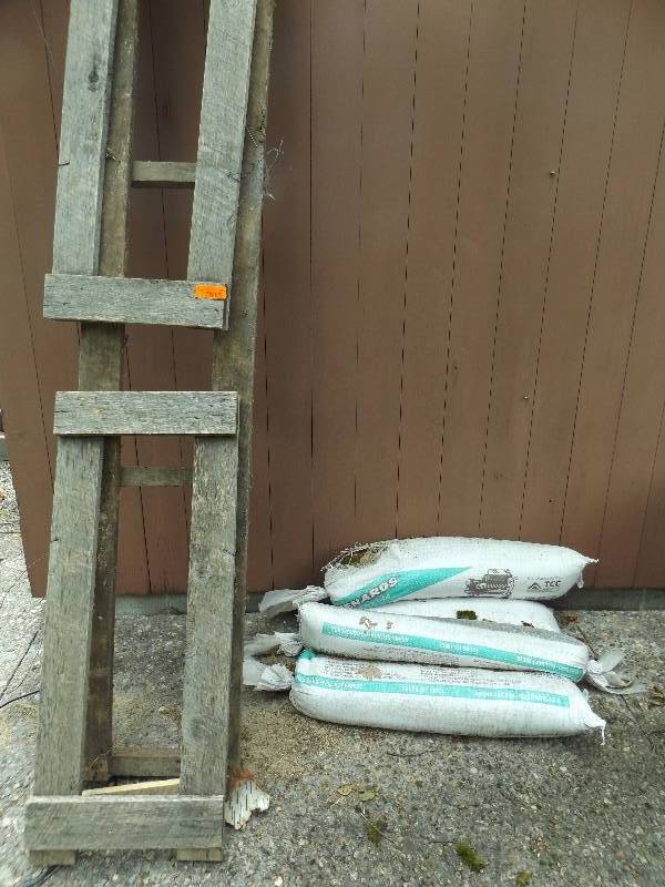 lot 555 image: 4 Sand Bags, Rack for Firewood