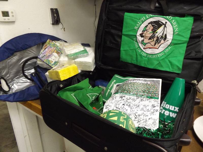 lot 317 image: Suitcases and UND Paraphanalia