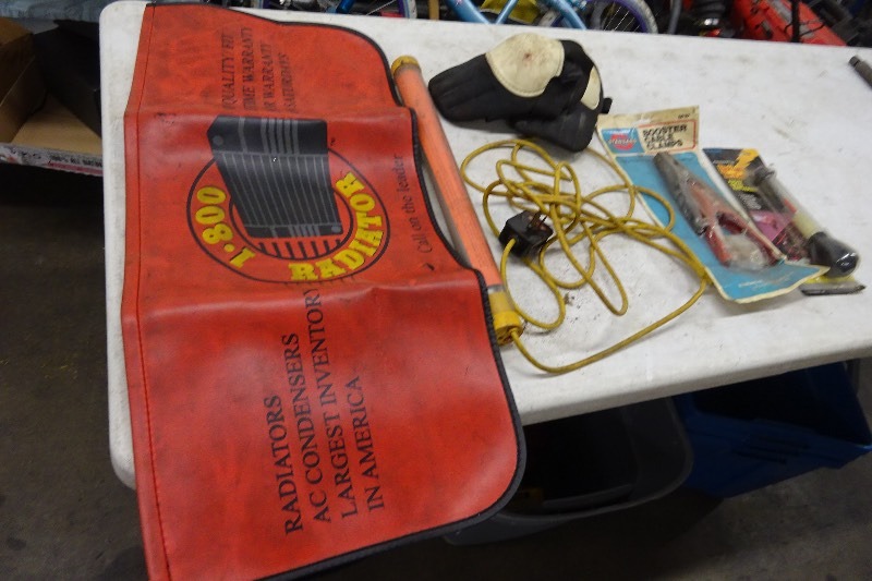Fender cover, batter tester, knee pads, light, booster cable clamps