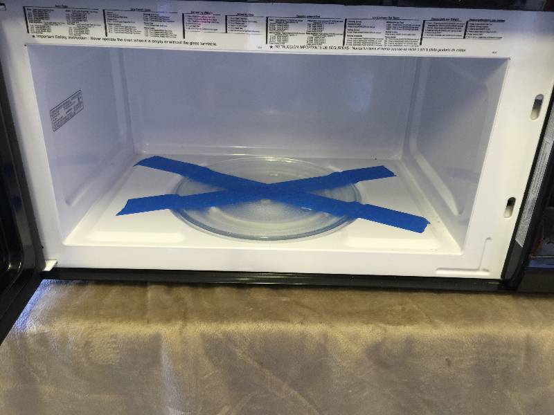 lot 123 image: Magic Chef 1.6 cu. Ft. Overt - the- Range Microwave in Black