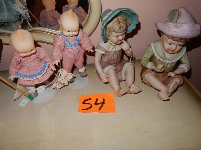 lot 54 image: Boy and Girl Sitting.. Porcelain Dolls 2 Kewpie Dolls