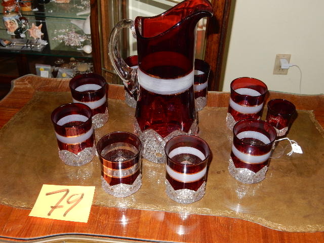 lot 79 image: Cranberry and cut glass Pitcher and 8 glasses.  Small pedestal cordial