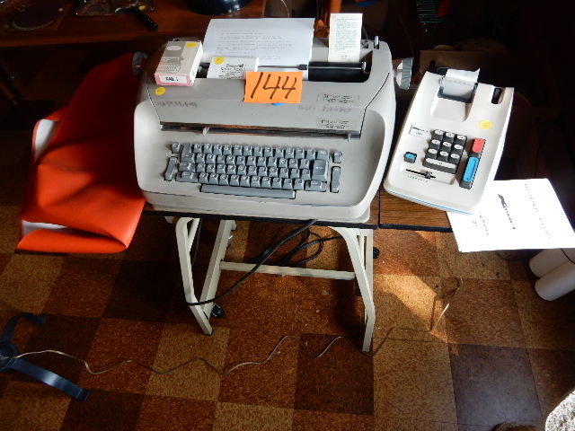 lot 144 image: IBM Selectric Type Writer, K MART, Adding Machine.. Typing Table and cover.