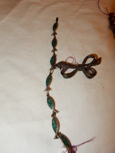 lot 1K image: 2 Bracelets, 1, with fish theme, 1 matches bow pin. Small flecks of jewels distributed.. Bow Pin, with jewel flecks.