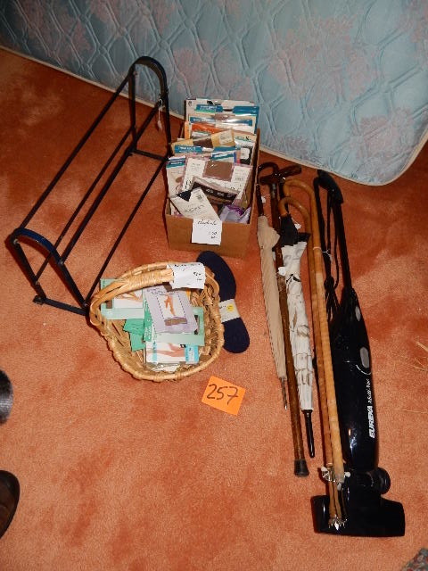 lot 257 image: canes, umbrella, Eureka electric vacuum, Large lot of Nylon stockings.. New in their packages, but pretty VINTAGE