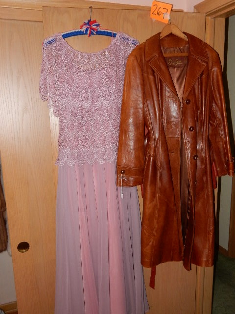 lot 267 image: 2 leather coats.. Skin Gear, made in Mexico.. The shorter, red leather one is size 46 womens.. Both have belts.  Womans evening dress. Pink, With fishnet type top and sheer silky bottom material. .Im sure a medium size..
