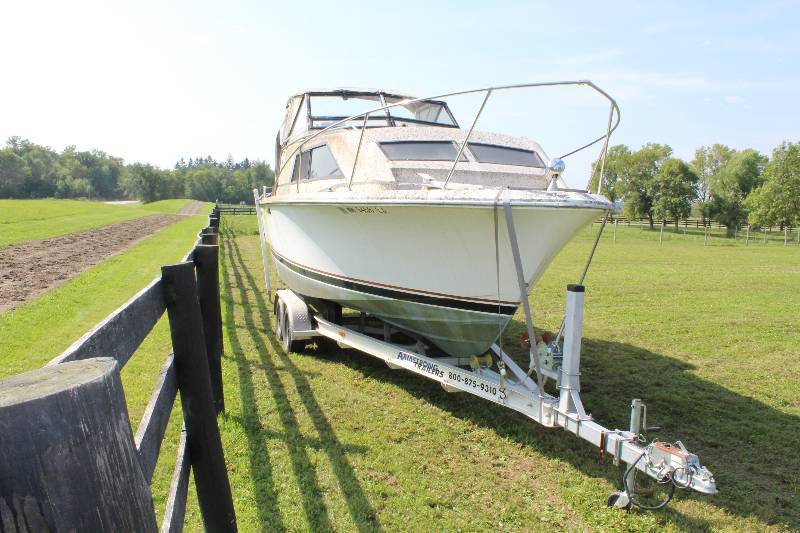 lot 4 image: 1980 Trojan 25 Foot Boat wOverhead Awning & Trailer Lower Cabin wSleeping Quarters, Couch, Bathroom & Kitchenette Gas Gauge Depth Finder.