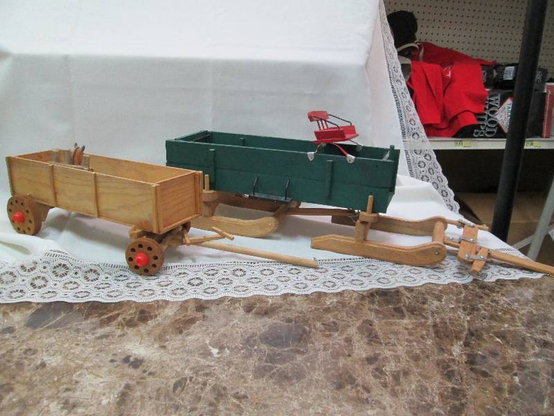 Wooden wagons one on wheels, one ha...