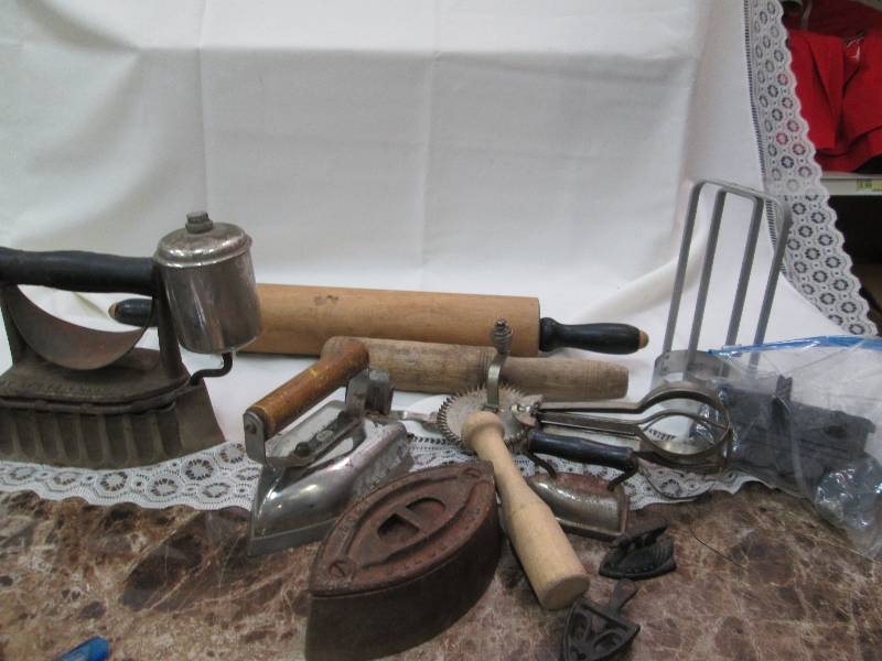 Old time irons, rolling pin, and mo...