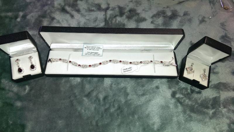 Two pairs of pierced earrings and a bracelet (diamond, garnet and cubic zirconia).