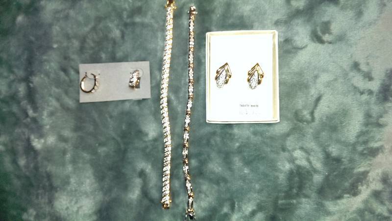 Two pairs of pierced earrings and two bracelets.
